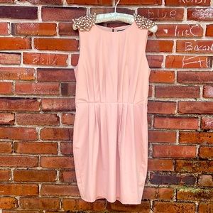 Beaded accented pastel pink mini dress with pearl shoulder pads & open back